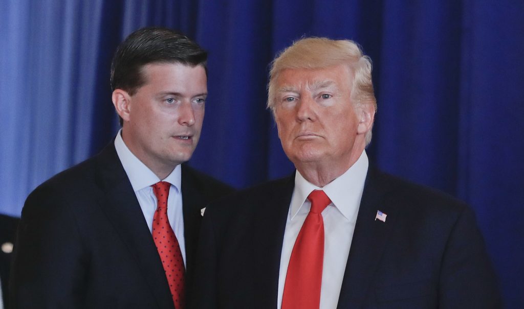 Rob Porter, left, White House Staff Secretary speaks to President Donald Trump after Trump made remarks regarding the on going situation in Charlottesville, Va., Saturday, Aug. 12, 2017 at Trump National Golf Club in Bedminister, N.J. Porter reminded Trump that he still needed to sign the Veteran's Affairs Choice and Quality Employment Act of 2017. (AP Photo/Pablo Martinez Monsivais)