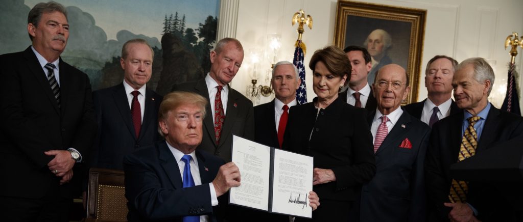 President Donald Trump shows off a signed Presidential Memorandum imposing tariffs and investment restrictions on China, in the Diplomatic Reception Room of the White House, Thursday, March 22, 2018, in Washington. (AP Photo/Evan Vucci)