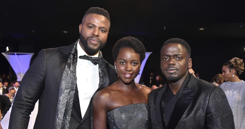 Winston Duke, from left, Lupita Nyong'o and Daniel Kaluuya pose in the audience at the 24th annual Screen Actors Guild Awards at the Shrine Auditorium & Expo Hall on Sunday, Jan. 21, 2018, in Los Angeles. (Photo by Vince Bucci/Invision/AP)