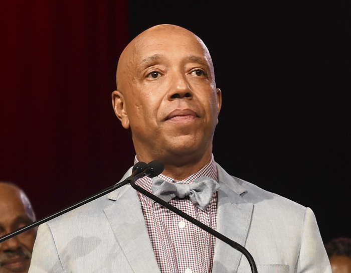 FILE - In this July 18, 2015 file photo, Russell Simmons speaks appears at the RUSH Philanthropic Arts Foundation's Art for Life Benefit in Water Mill, N.Y. Three women have told the New York Times that music mogul Russell Simmons raped them. Simmons, in a statement to the paper, vehemently denied what he called “these horrific accusations,” saying all his relations have been consensual. (Photo by Scott Roth/Invision/AP, File)
