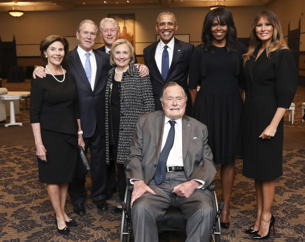 This Saturday, April 21, 2018, photo provided by the Office of former U.S. President George H.W. Bush, shows Bush, front center, and past presidents and first ladies Laura Bush, from left, George W. Bush, Bill Clinton, Hillary Clinton, Barack Obama, Michelle Obama and current first lady Melania Trump in a group photo at the funeral service for former first lady Barbara Bush, in Houston. Barbara Bush died Tuesday, April 17. She was 92. (Paul Morse/Courtesy of Office of George H.W. Bush via AP)