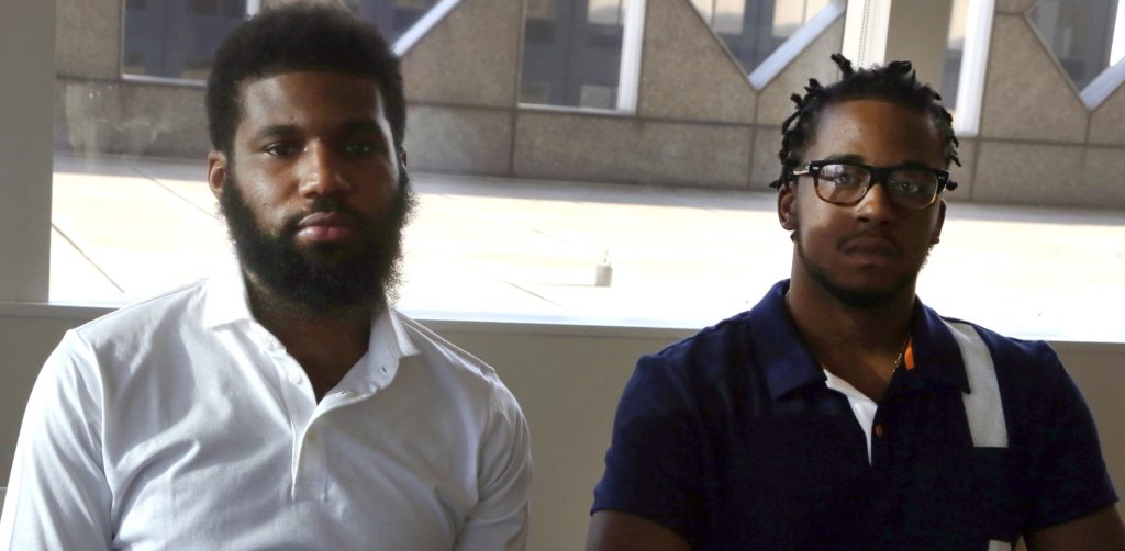Rashon Nelson, left, and Donte Robinson, right, both 23, sit in their attorney's conference room as they pose for a portrait following an interview with the Associated Press Wednesday April 18, 2018 in Philadelphia. Their arrests at a local Starbucks quickly became a viral video and galvanized people around the country who saw the incident as modern-day racism. In the week since, Nelson and Robinson have met with Starbucks CEO Kevin Johnson and are pushing for lasting changes to ensure that what happened to them doesn't happen to future patrons. They are also still processing what it means to have had an everyday encounter escalate into a police confrontation. (AP Photo/Jacqueline Larma)