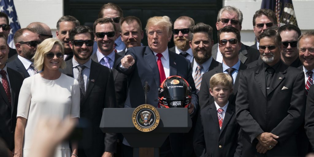 President Donald Trump poses with 2017 NASCAR Cup champion Martin Truex Jr., second from left, Truex's long time girlfriend Sherry Pollex, left, and members of his racing team during a ceremony on the South Lawn of the White House in Washington, Monday, May 21, 2018. (AP Photo/Andrew Harnik)