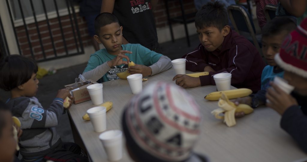 Children have their breakfast at the "Vina de Tijuana AC" migrant shelter in Tijuana, Mexico, Saturday, April 28, 2018. As the migrants prepare to walk to the "Casa del Tunel" to get legal advice from U.S. immigration lawyers, they are telling Central Americans in a caravan of asylum-seekers they may be separated from their children and detained for many months.  (AP Photo/Hans-Maximo Musielik)
