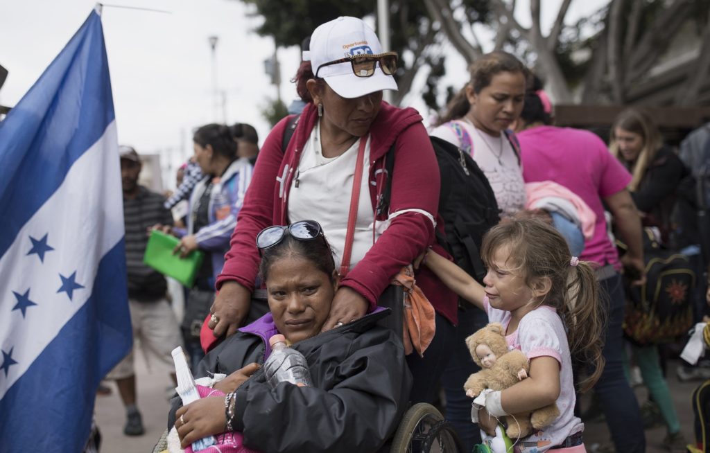 Members of a Central American family traveling with a caravan of migrants prepare to cross the border and apply for asylum in the United States, in Tijuana, Mexico, Sunday, April 29, 2018. A group of Central Americans who journeyed in a caravan to the U.S. border resolved to turn themselves in and ask for asylum Sunday in a direct challenge to the Trump administration - only to have U.S. immigration officials announce that the San Diego crossing was already at capacity. (AP Photo/Hans-Maximo Musielik)