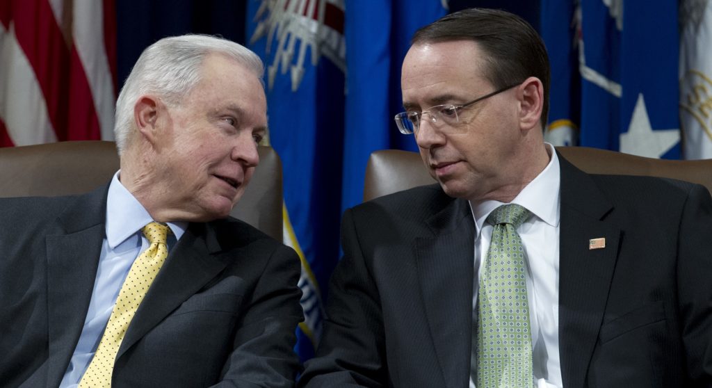 Attorney General Jeff Sessions speaks with Deputy Attorney General Rod Rosenstein during the opening ceremony of the summit on Efforts to Combat Human Trafficking at Department of Justice in Washington, Friday, Feb. 2, 2018. President Donald Trump, dogged by an unrelenting investigation into his campaign's ties to Russia, lashes out at the FBI and Justice Department as politically biased ahead of the expected release of a classified Republican memo criticizing FBI surveillance tactics. (AP Photo/Jose Luis Magana)