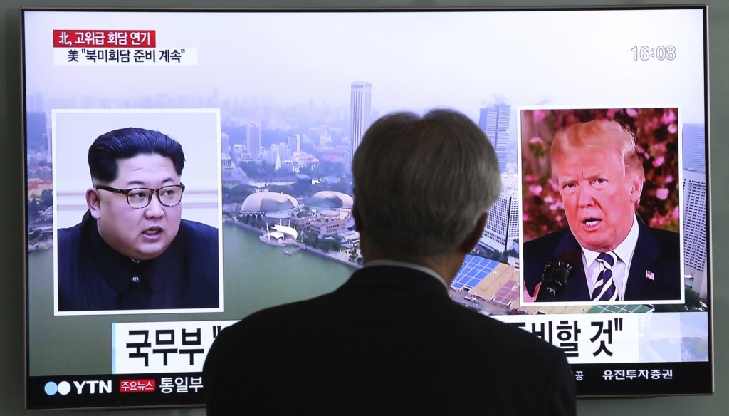 A man watches a TV screen showing file footage of U.S. President Donald Trump, right, and North Korean leader Kim Jong Un during a news program at the Seoul Railway Station in Seoul, South Korea, Wednesday, May 16, 2018. North Korea's breaking off a high-level meeting with South Korea and threatening to scrap next month's historic summit with President Trump over allied military drills is seen as a move by Kim to gain leverage and establish that he's entering the crucial nuclear negotiations from a position of strength. Washington and Seoul, which have no intentions to overpay for whatever Kim brings to the table, say international sanctions forced Kim into talks after a flurry of weapons tests. (AP Photo/Ahn Young-joon)