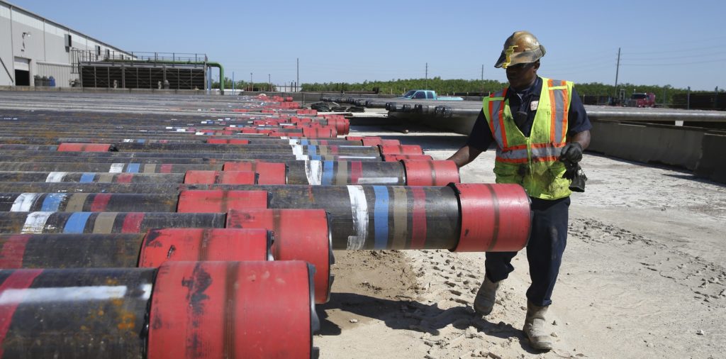 Taurice Jones inspects steel pipes as part of quality control at the Borusan Mannesmann plant in Baytown, Texas, Monday, April 23, 2018. President Donald Trump's escalating dispute with China over trade and technology is threatening jobs and profits in working-class communities where his "America First" agenda hit home. Without a waiver, Borusan Mannesmann Pipe may face tariffs of $25 million to $30 million annually if it imports steel tubing and casing from its parent company in Turkey, according to information the company provided to The Associated Press. (AP Photo/Loren Elliott)