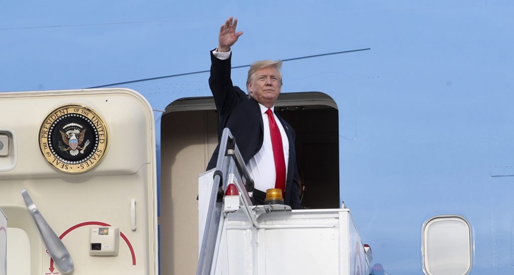 In this photo released by the Ministry of Communications and Information, Singapore, U.S. President Donald Trump waves as he boards Air Force One following a summit with North Korean leader Kim Jong Un Tuesday, June 12, 2018, in Singapore. (Ministry of Communications and Information, Singapore via AP)