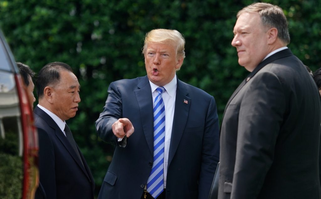 President Donald Trump talks with Kim Yong Chol, left, former North Korean military intelligence chief and one of leader Kim Jong Un's closest aides, after their meeting in the Oval Office of the White House in Washington, Friday, June 1, 2018, as Secretary of State Mike Pompeo listens at right. (AP Photo/Andrew Harnik)