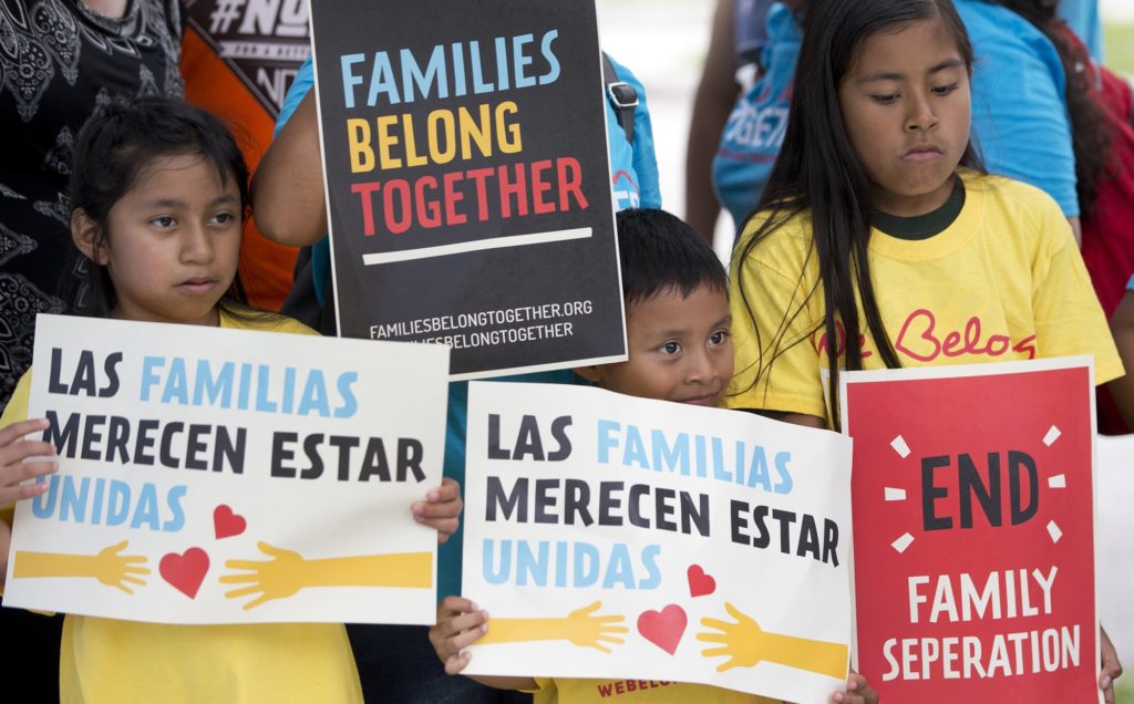 FILE - In this June 1, 2018, file photo, children hold signs during a demonstration in front of the Immigration and Customs Enforcement offices in Miramar, Fla. The Trump administration's move to separate immigrant parents from their children on the U.S.-Mexico border has turned into a full-blown crisis in recent weeks, drawing denunciation from the United Nations, Roman Catholic bishops and countless humanitarian groups. (AP Photo/Wilfredo Lee, File)