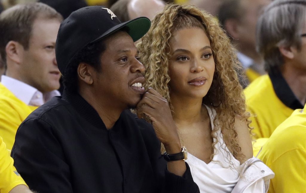 Jay-Z and Beyonce watch Game 1 of an NBA basketball second-round playoff series between the Golden State Warriors and the New Orleans Pelicans on Saturday, April 28, 2018, in Oakland, Calif. (AP Photo/Marcio Jose Sanchez)