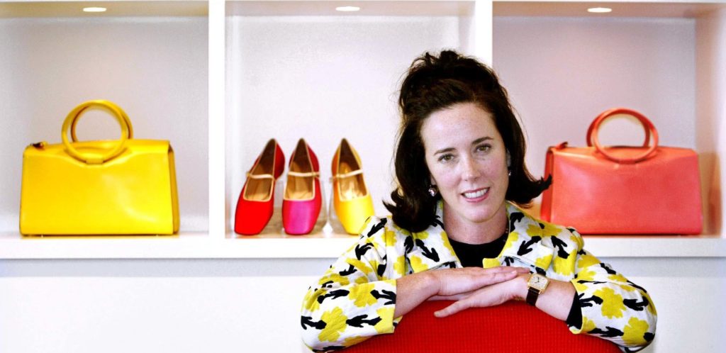 FILE - In this May 13, 2004 file photo, designer Kate Spade poses with handbags and shoes from her next collection in New York. Law enforcement officials say Tuesday, June 5, 2018, that New York fashion designer Kate Spade has been found dead in her apartment in an apparent suicide. (AP Photo/Bebeto Matthews, File)