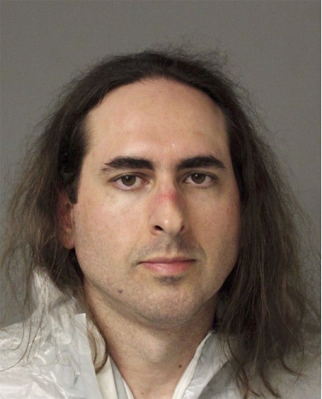 In this June 28 2018 photo released by the Anne Arundel Police, Jarrod Warren Ramos poses for a photo, in Annapolis, Md. First-degree murder charges were filed Friday against Ramos who police said targeted Maryland's capital newspaper, shooting his way into the newsroom and killing four journalists and a staffer before officers swiftly arrested him. (Anne Arundel Police via AP)