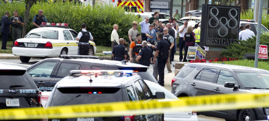Authorities stage at the office building entrance after multiple people were shot at The Capital Gazette newspaper in Annapolis, Md., Thursday, June 28, 2018. (AP Photo/Jose Luis Magana)