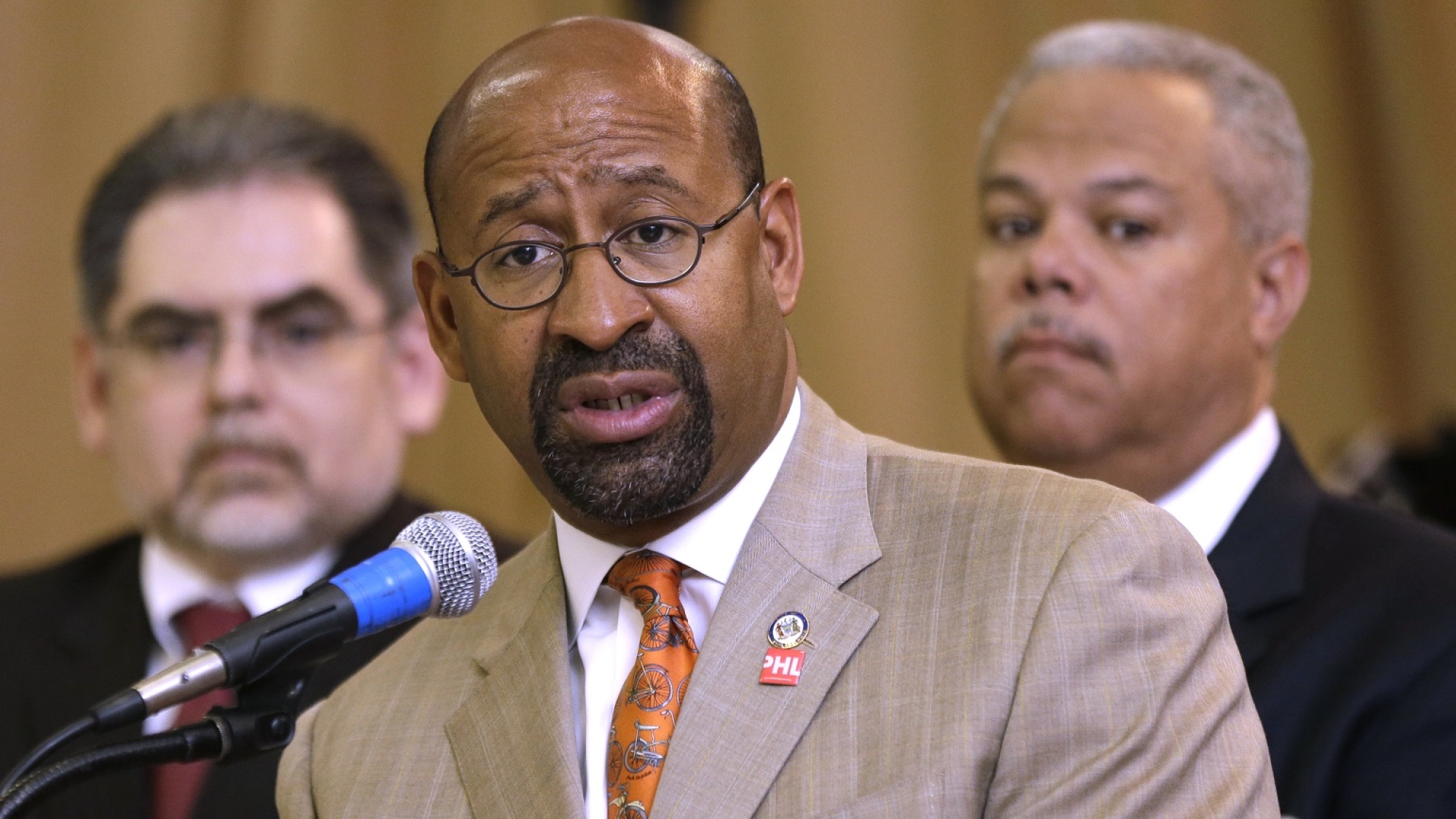 Mayor Michael Nutter, accompanied by Pedro A. Ramos, Chairman, School Reform Commission, left, and state Sen. Anthony Williams D-Philadelphia, speaks during a news conference at Andrew Jackson Public School, Thursday, May 9, 2013, in Philadelphia. After days of protests and walkouts by city students concerned about budget cuts, local officials called for additional funds for the Philadelphia school district. The system is facing a $300 million deficit, which education advocates say will devastate classrooms. (AP Photo/Matt Rourke)