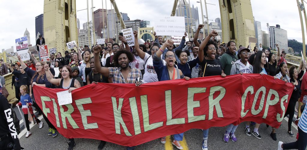 Protestors cross the Roberto Clemente bridge during a evening rush hour march that began in downtown Pittsburgh Friday, June 22, 2018. They are protesting the killing of Antwon Rose Jr. who was fatally shot by a police officer seconds after he fled a traffic stop late Tuesday, in the suburb of East Pittsburgh. (AP Photo/Gene J. Puskar)