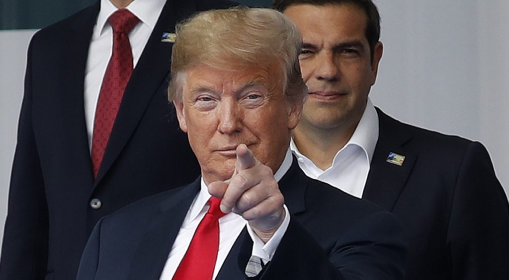 President Donald Trump points with his fingers towards members of the media during a family photo at a summit of heads of state and government at NATO headquarters in Brussels on Wednesday, July 11, 2018. NATO leaders gather in Brussels for a two-day summit to discuss Russia, Iraq and their mission in Afghanistan. (AP Photo/Pablo Martinez Monsivais)