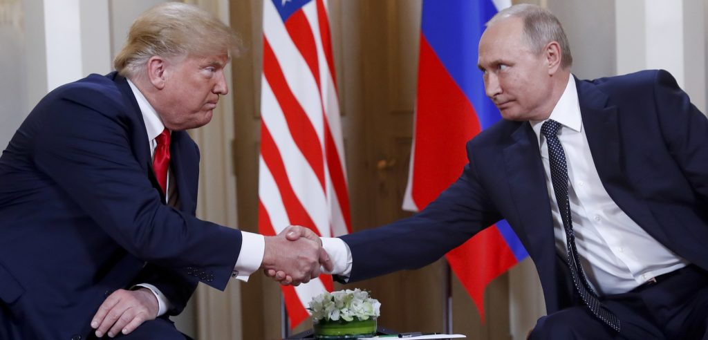 U.S. President Donald Trump, left, and Russian President Vladimir Putin, right, shake hand at the beginning of a meeting at the Presidential Palace in Helsinki, Finland, Monday, July 16, 2018. (AP Photo/Pablo Martinez Monsivais)