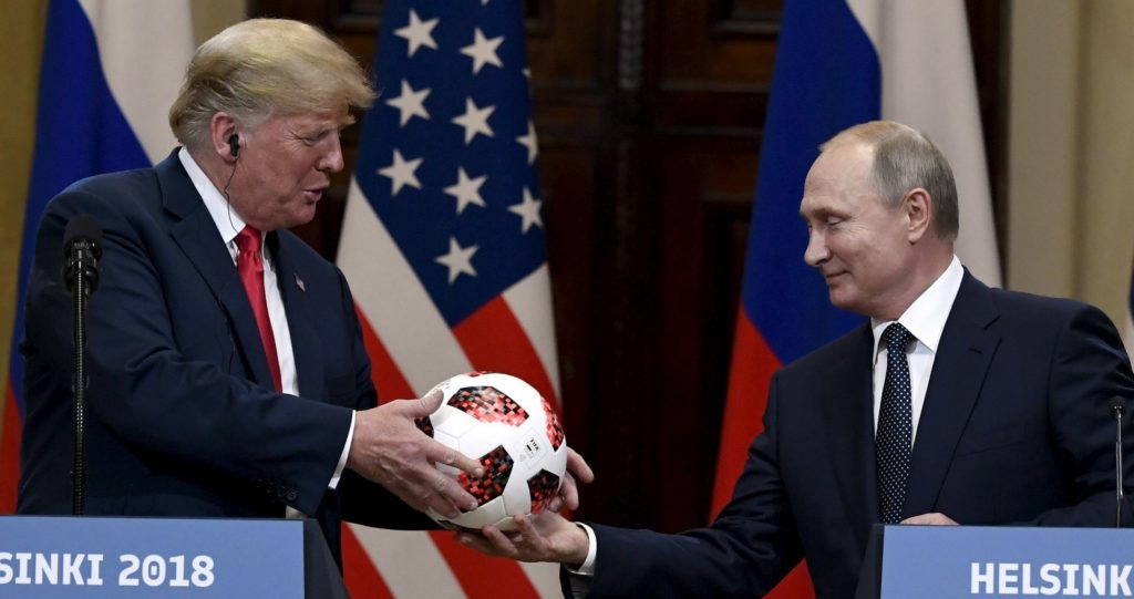 Russian President Vladimir Putin presents a soccer ball to U.S. President Donald Trump during a joint press conference at the Presidential Palace in Helsinki, Finland, Monday, July 16, 2018. (Jussi Nukari/Lehtikuva via AP)
