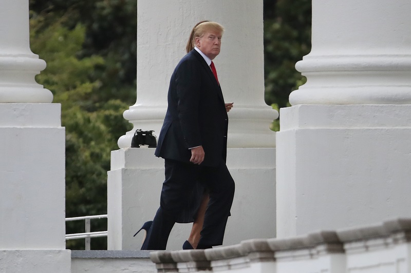 President Donald Trump and first lady Melania Trump walk on the North Portico as they arrive back to the White House in Washington, Sunday, July 22, 2018, from weekend trip to Bedminster, N.J. (AP Photo/Manuel Balce Ceneta)