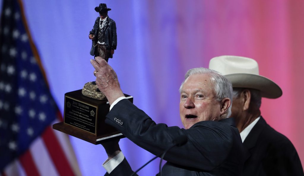 U.S. Attorney General Jeff Sessions receives the National Sheriffs' Association Lifetime Achievement Award before he speaks at their convention in New Orleans, Monday, June 18, 2018. (AP Photo/Gerald Herbert)