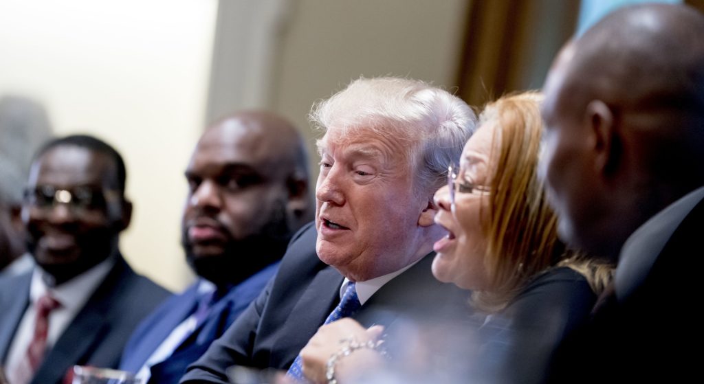 President Donald Trump, center, reacts as Dr. Alveda King with Alveda King Ministries, second from right, speaks during a meeting with inner city pastors in the Cabinet Room of the White House in Washington, Wednesday, Aug. 1, 2018. (AP Photo/Andrew Harnik)