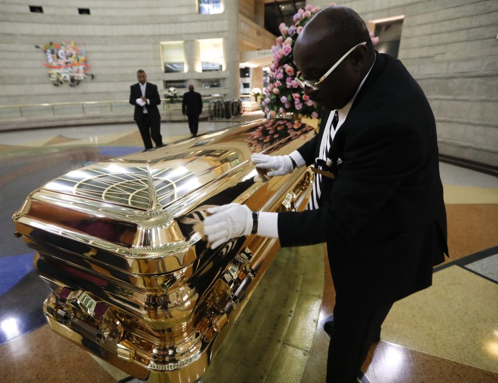 Vincent Street wipes down the casket of legendary singer Aretha Franklin at the Charles H. Wright Museum of African American History in Detroit, Wednesday, Aug. 29, 2018. Franklin died Aug. 16, 2018 of pancreatic cancer at the age of 76. (AP Photo/Paul Sancya)