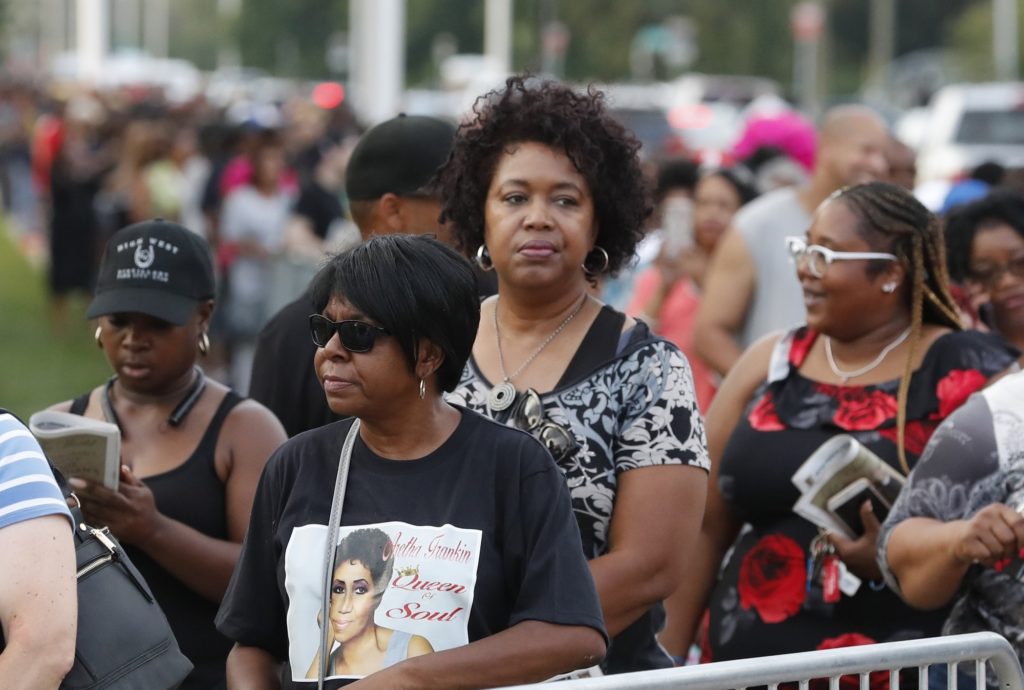 Fans wait in line at the Charles H. Wright Museum of African American History where Aretha Franklin is lying in state, Tuesday, Aug. 28, 2018, in Detroit. (AP Photo/Carlos Osorio)