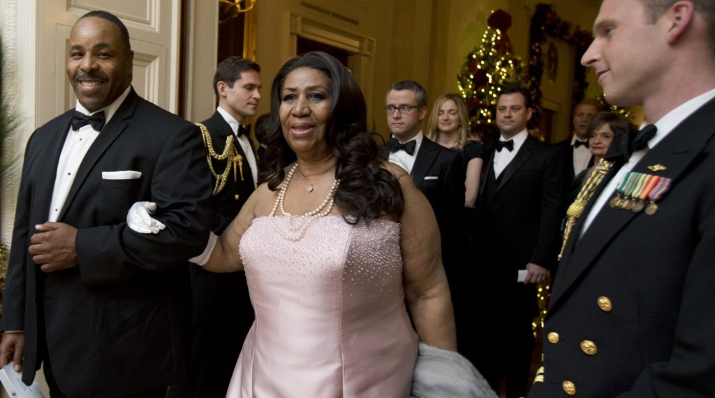Singer Aretha Franklin, center, arrives at  a reception hosted by President Barack Obama and first lady Michelle Obama in honor of the 2012 Kennedy Center Honors recipients, in the East Room of the White House in Washington, Sunday, Dec. 2, 2012.   (AP Photo/Manuel Balce Ceneta)