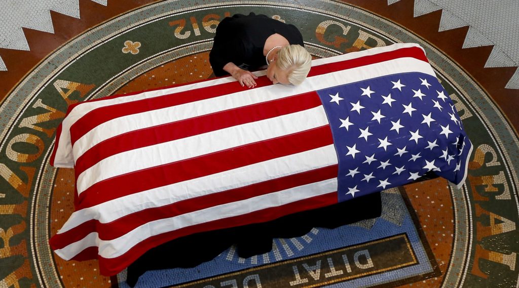 Cindy McCain, wife of, Sen. John McCain, R-Ariz. lays her head on casket during a memorial service at the Arizona Capitol on Wednesday, Aug. 29, 2018, in Phoenix. (AP Photo/Ross D. Franklin, Pool)