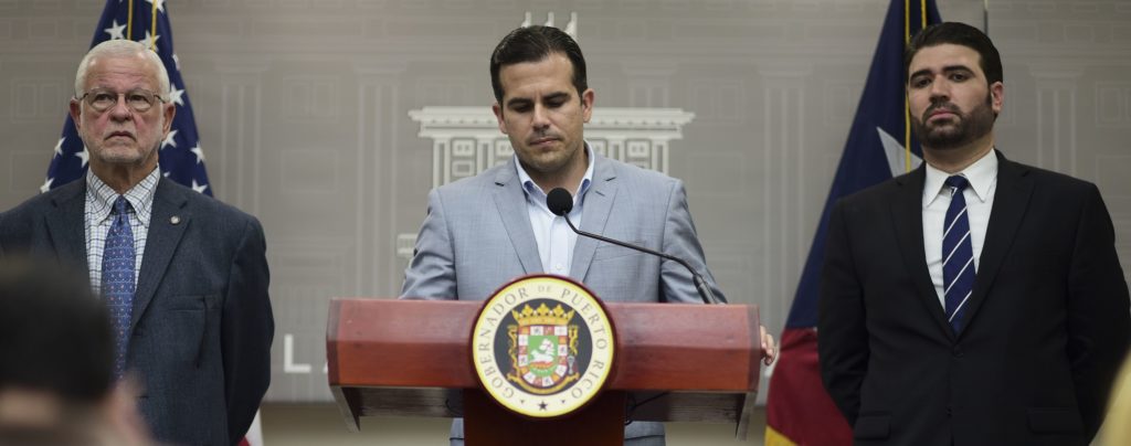 Public Safety Secretary Hector Pesquera, from left, Executive Director of the Puerto Rico Federal Affairs Administration, PRFAA), Carlos Mercader and Puerto Rico Gov. Ricardo Rossello, attend a press conference regarding the number of estimated deaths in the aftermath of Hurricane Maria, in San Juan, Puerto Rico, Tuesday, Aug. 28, 2018.  (AP Photo/Carlos Giusti)