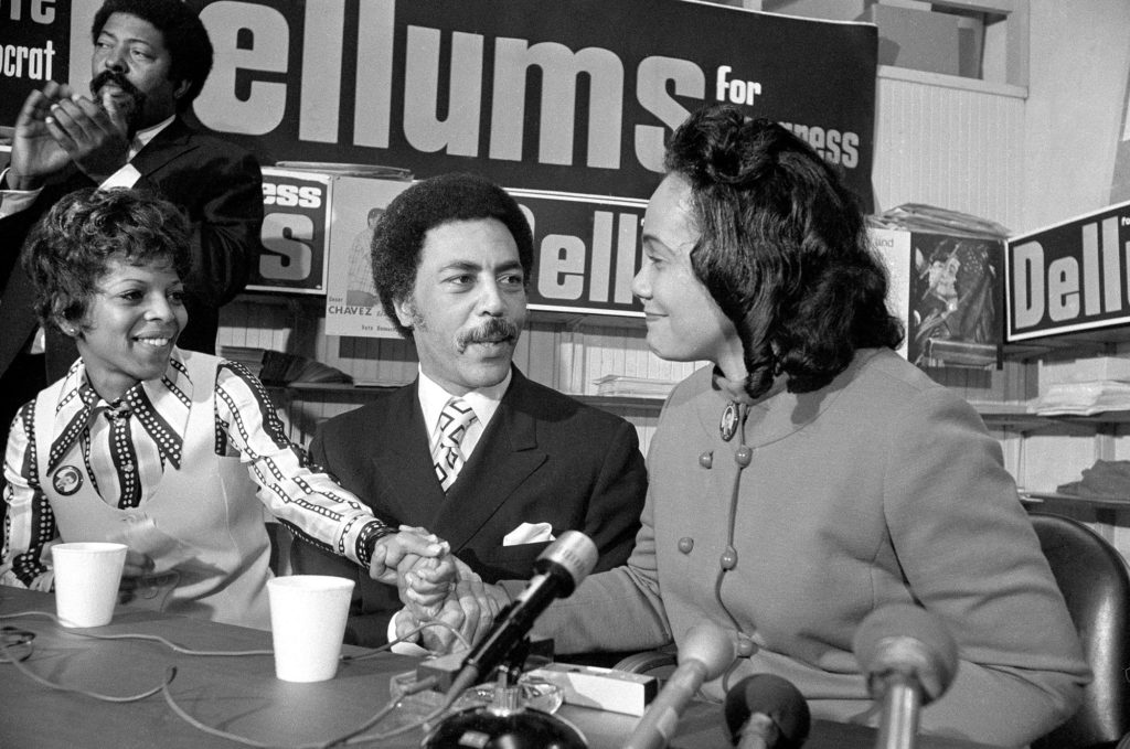 FILE - In this Oct. 30, 1970 file photo Democratic Congressional candidate Ron Dellums, his wife, Roscoe, left, clasp hands with Mrs. Coretta Scott King, right, widow of Martin Luther King in Oakland, Calif. Mrs. King appeared at a press conference in Oakland to endorse Dellum's candidacy for the Oakland-Berkeley congressional district. Dellums, a fiery anti-war activist who championed social justice as Northern California's first black congressman, died Monday, July 30, 2018, at age 82 from cancer, according to a longtime adviser. (AP Photo/Lennox McLendon, File)