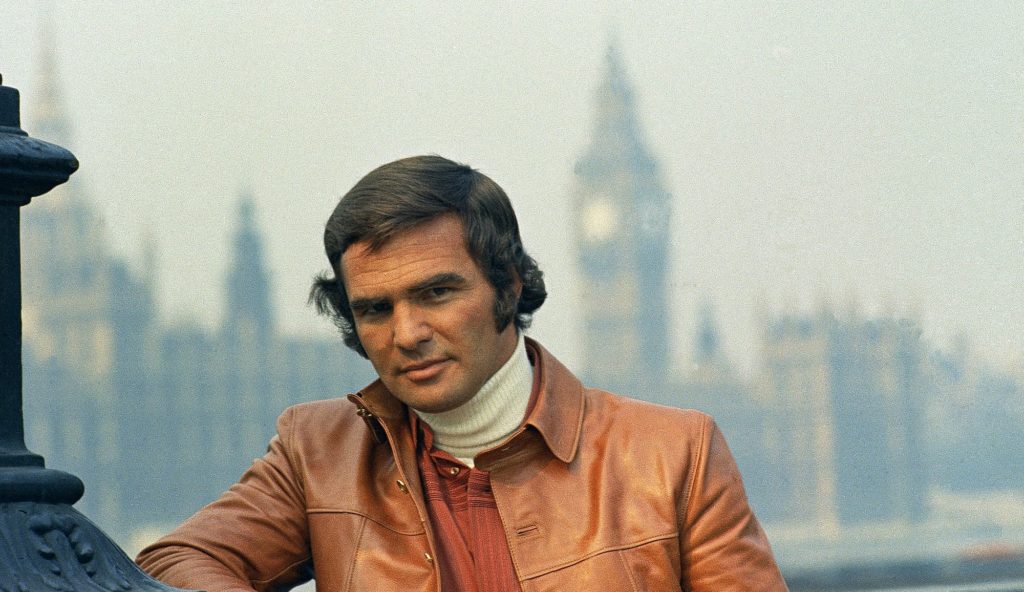 American actor Burt Reynolds is shown in London against a backdrop of the House of Parliament, Sept. 27, 1972. (AP Photo)