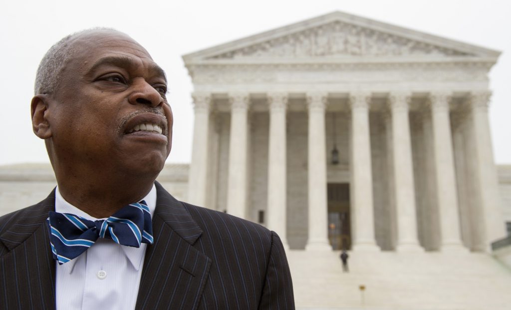 FILE - In this Wednesday, Dec. 9, 2015, file photo, Wade Henderson, president of the Leadership Conference on Civil and Human Rights, waits outside the Supreme Court in Washington as the court heard oral arguments in the Fisher v. University of Texas at Austin affirmative action case. The nation's largest civil rights groups said it will closely monitor President-elect Donald Trump and his incoming administration's policies and actions to ensure that hard-fought civil rights gains are not lost without a protracted fight. "We will not accept proposals to roll back civil rights ... not on our watch," Henderson, president of Leadership Conference on Civil and Human Rights, said Monday, Nov. 14, 2016. (AP Photo/Cliff Owen, File)