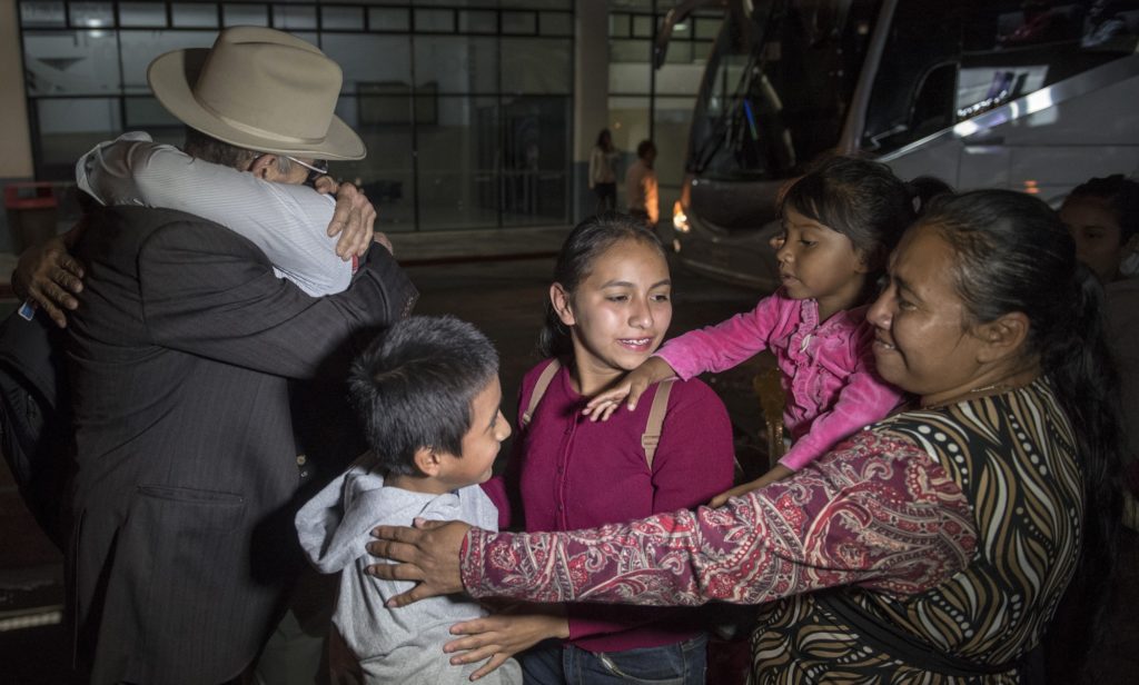 Relatives greet to Anthony David Tovar Ortiz, center, after arriving to La Aurora airport in Guatemala City, Tuesday, Aug. 14, 2018. The 8-year-old stayed in a shelter for migrant children in Houston after his mother Elsa Ortiz Enriquez was deported in June 2018 under President Donald Trump administration's zero tolerance policy. (AP Photo/Oliver de Ros)
