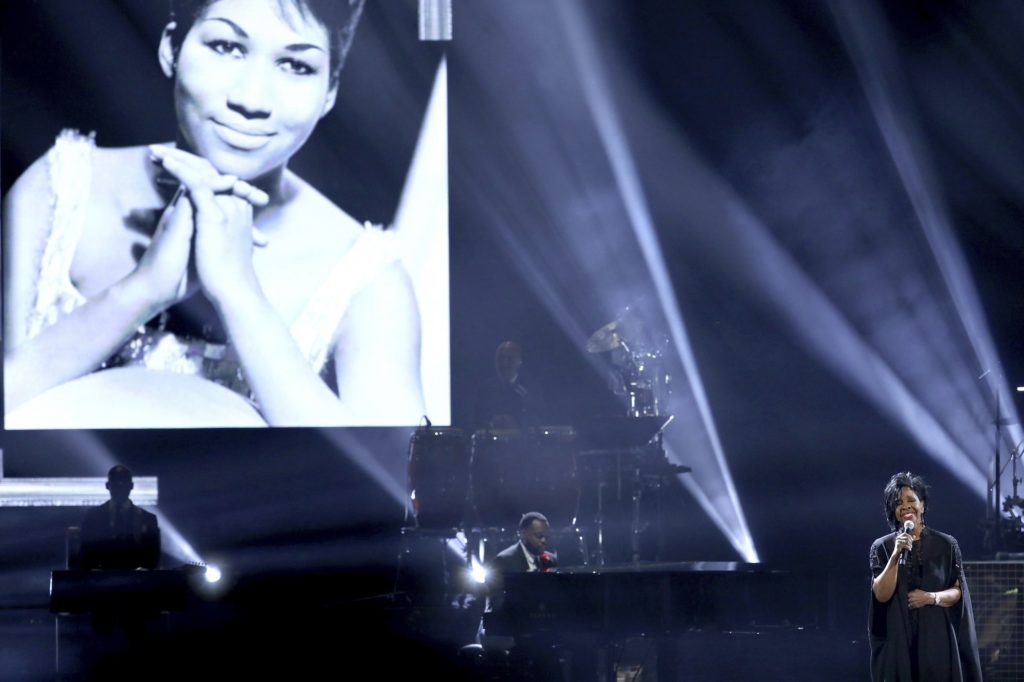 Gladys Knight performs "Amazing Grace" during a tribute to the late singer Aretha Franklin, pictured on screen, at the American Music Awards on Tuesday, Oct. 9, 2018, at the Microsoft Theater in Los Angeles. (Photo by Matt Sayles/Invision/AP)
