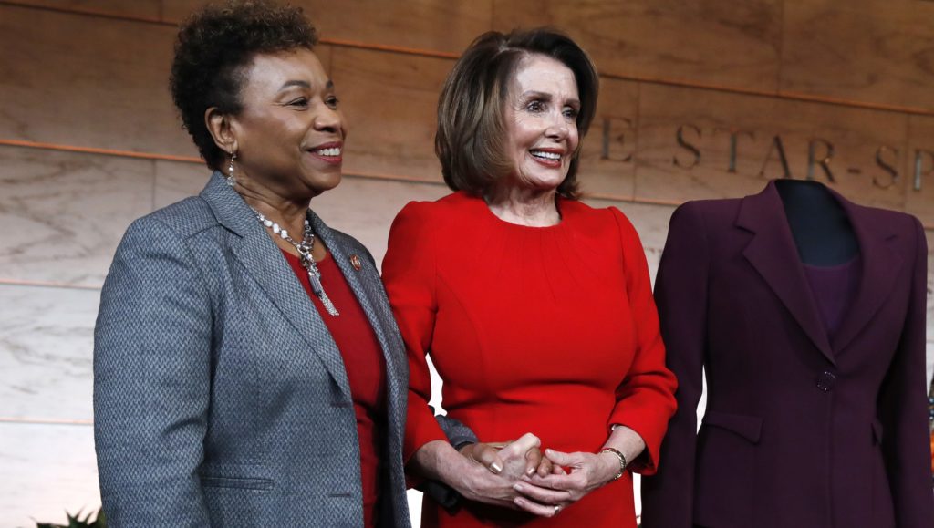 House Minority Leader Nancy Pelosi of Calif., right, stands with Rep. Barbara Lee, D-Calif., during a donation ceremony at the Smithsonian's National Museum of American History Wednesday, March 7, 2018. Pelosi donated items including her gavel, a burgundy dress she wore to her swearing in, and the original speech she gave from January 4, 2007. Next to the dress Pelosi donated is a dress worn by Marian Anderson, who was the first African American to perform with the Metropolitan Opera, when she performed at the Lincoln Memorial in 1939. Pelosi was the first woman Speaker of the House.  (AP Photo/Jacquelyn Martin)