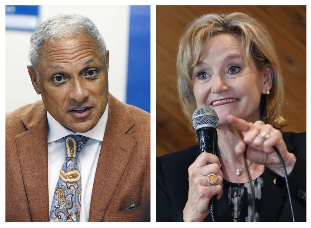 This combination photo shows Mike Espy, left, a former congressman and former U.S. agriculture secretary, on Oct. 5, 2018, and U.S. Sen. Cindy Hyde-Smith, R-Miss., on Nov. 5, 2018, both in Jackson, Miss. The last U.S. Senate race of the midterms was coming to a close Tuesday, Nov. 27, 2018, as Mississippi residents chose between Hyde-Smith, a white Republican Senate appointee whose "public hanging" comments angered many people, and Espy, a black Democrat who was agriculture secretary when Bill Clinton was in the White House. (AP Photo/Rogelio V. Solis, File)