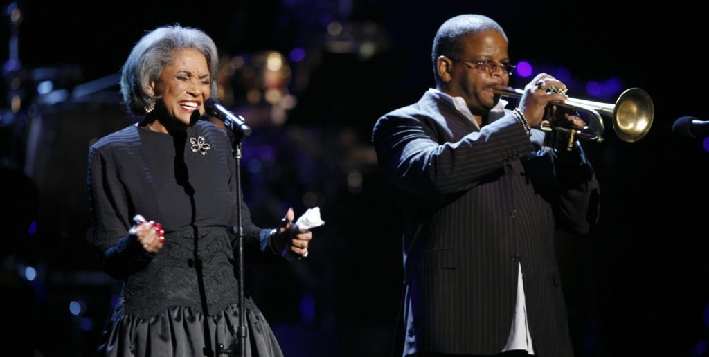 FILE - In this Oct. 28, 2007 file photo, Nancy Wilson, left, and Terence Blanchard, right, perform during an all-star tribute concert for Herbie Hancock, in Los Angeles. Grammy-winning jazz and pop singer Wilson has died at age 81. Her manager Devra Hall Levy tells The Associated Press late Thursday night, Dec. 13, 2018, that Wilson died peacefully after a long illness at her home in Pioneertown, a California desert community near Joshua Tree National Park. (AP Photo/Rene Macura, File)