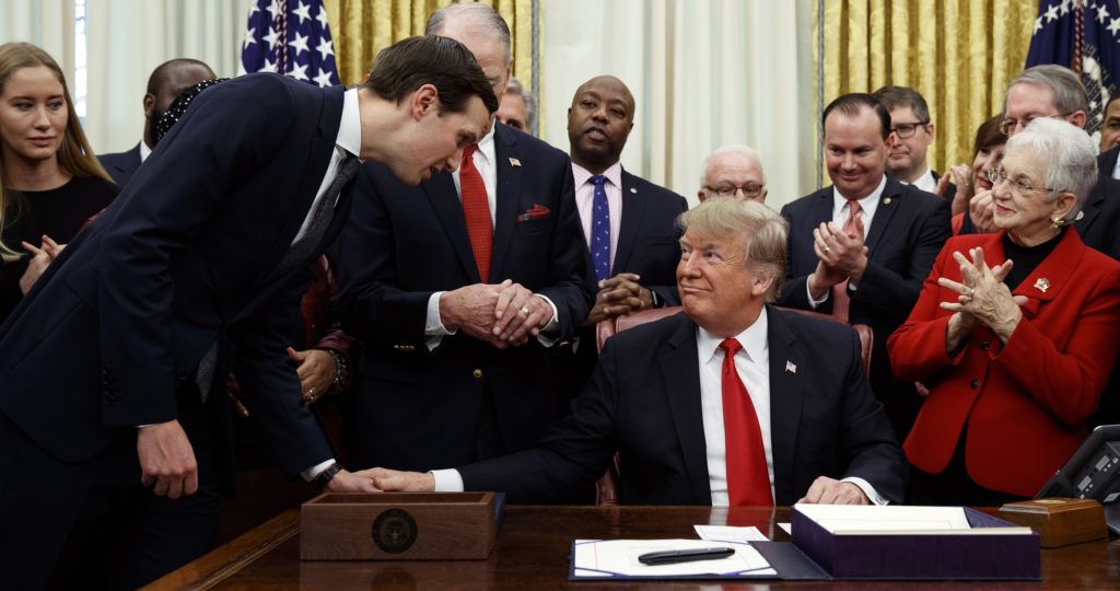 White House senior adviser Jared Kushner talks with President Donald Trump during a signing ceremony for criminal justice reform legislation in the Oval Office of the White House, Friday, Dec. 21, 2018, in Washington. (AP Photo/Evan Vucci)