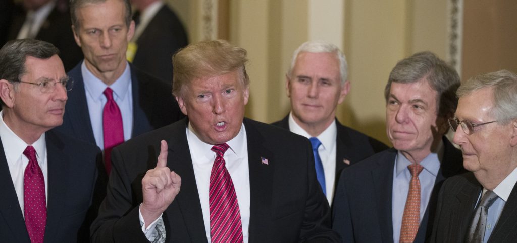 Sen. John Barrasso, R-Wyo., left, and Sen. John Thune, R-S.D., stand with President Donald Trump, Vice President Mike Pence, Sen. Roy Blunt, R-Mo., and Senate Majority Leader Mitch McConnell of Ky., as Trump speaks while departing after a Senate Republican Policy luncheon, on Capitol Hill in Washington, Wednesday, Jan. 9, 2019. (AP Photo/Alex Brandon)
