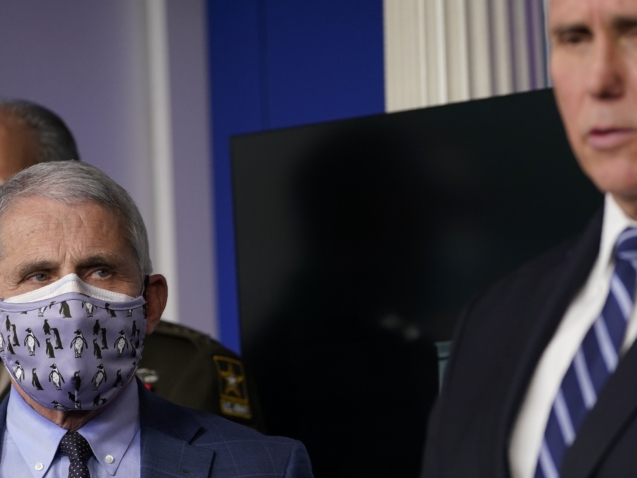 Dr. Anthony Fauci, director of the National Institute of Allergy and Infectious Diseases, left, listens as Vice President Mike Pence, right, speaks during a news conference with the coronavirus task force at the White House in Washington, Thursday, Nov. 19, 2020. (AP Photo/Susan Walsh)