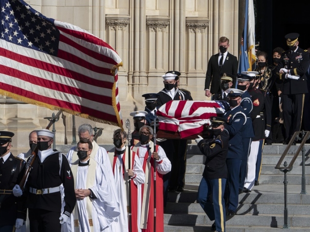 The flag-draped casket of former Secretary of State Colin Powell is carried from the Washington National Cathedral following a funeral service in Washington, Friday, Nov. 5, 2021. Alma Powell, follows the casket. (AP Photo/Manuel Balce Ceneta)