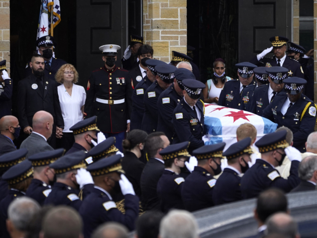 FILE - Elizabeth French, in white, and her son Andrew, left, follow the casket of her daughter, Chicago police officer Ella French, after a funeral service at the St. Rita of Cascia Shrine Chapel Thursday, Aug. 19, 2021, in Chicago. French was killed and her partner was seriously wounded during an Aug. 7 traffic stop on the city's South Side. The year 2021 ended as one of the deadliest on record in recent years in Chicago, according to statistics released by the city's police department on Saturday, Jan. 1, 2022. (AP Photo/Charles Rex Arbogast, File)