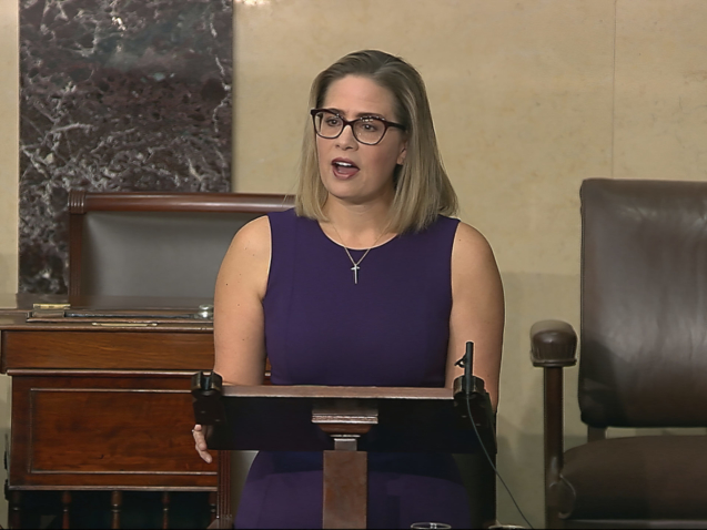 In this image from Senate Television, Sen. Kyrsten Sinema, D-Ariz., speaks on the floor of the U.S. Senate on Thursday, Jan. 13, 2022. President Joe Biden is set to meet privately with Senate Democrats at the Capitol, a visit intended to deliver a jolt to the party’s long-stalled voting and elections legislation. Before he arrived Sinema blunted the bill’s chances further, declaring she could not support a “short sighted” rules change to get past a Republican blockade. (Senate Television via AP)