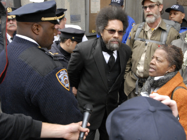 FILE- In this Oct. 21, 2011, file photo, Political activist, Dr. Cornel West, center, is taken into custody by New York City police officers at a "Stop and Frisk" policy protest in Manhattans Harlem neighborhood in New York. Joining nearly two dozen people, West goes to trial on Monday, April 30, 2012, in New York after being arrested at an October demonstration against the New York police departments practice of stopping and frisking hundreds of thousands of people each year as a crime-fighting tool. (AP Photo/Stephanie Keith, File)