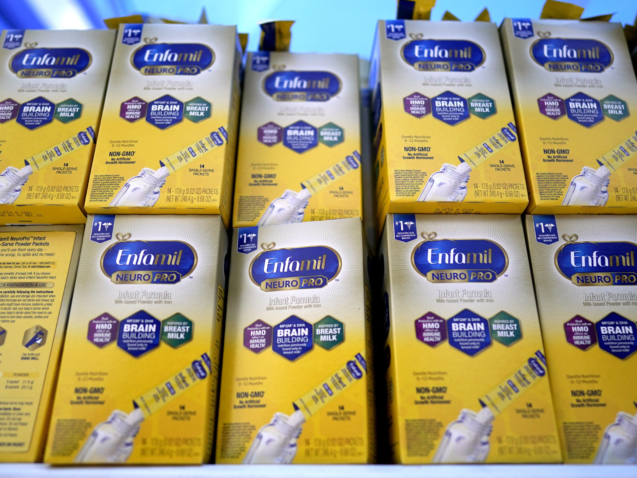 FILE - Infant formula is stacked on a table during a baby formula drive to help with the shortage May 14, 2022, in Houston.  President Joe Biden has invoked the Defense Production Act to speed production of infant formula and has authorized flights to import supply from overseas. (AP Photo/David J. Phillip, File)