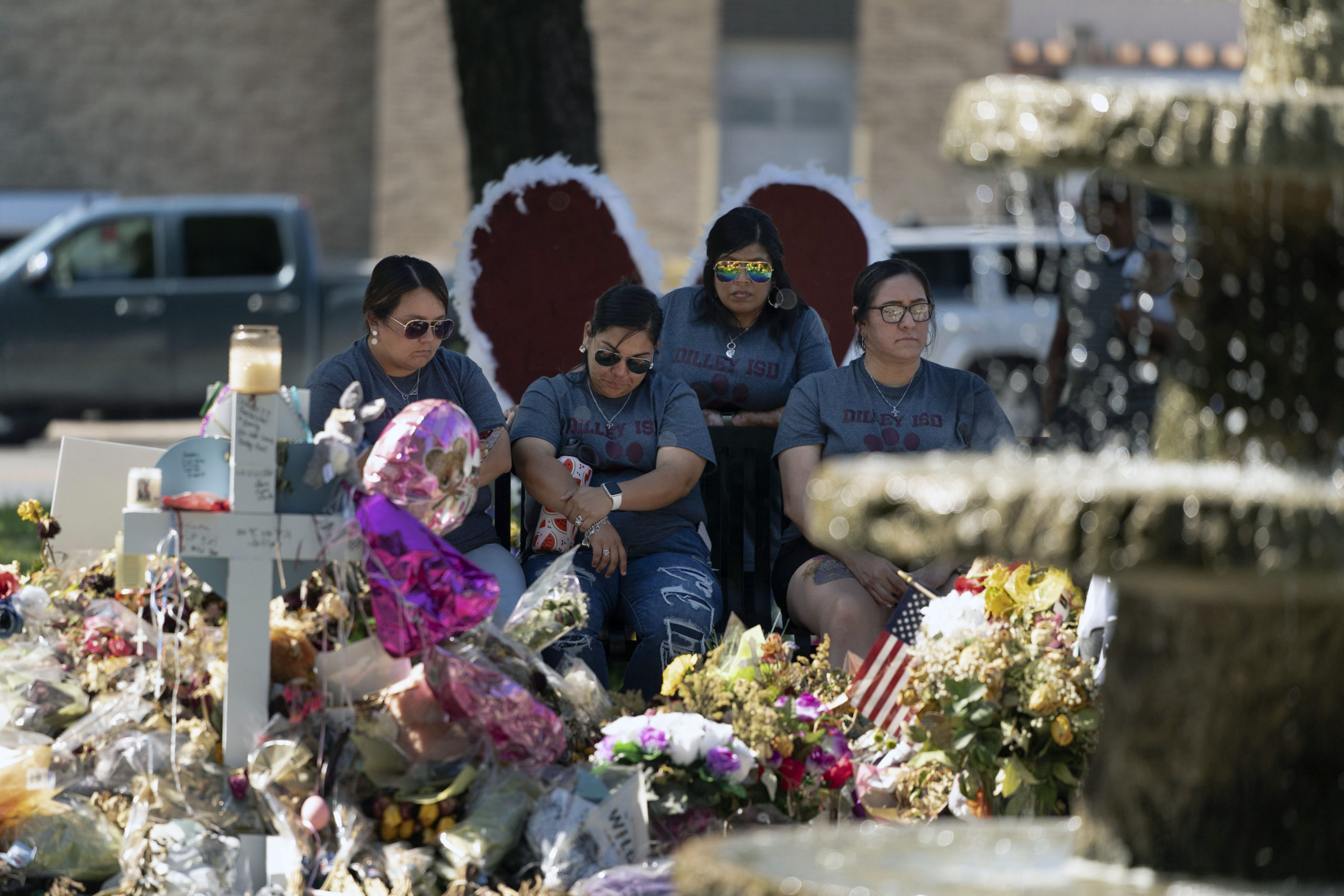 A group of teachers visiting from Dilley, Texas, view a memorial honoring the victims killed in the shooting in Uvalde, Texas, Friday, June 3, 2022.