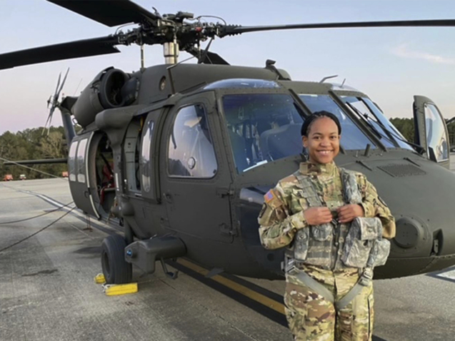 This undated photo provided by Louisiana National Guard shows Louisiana Army National Guard Warrant Officer Tatiana Julien in front of her National Guard helicopter. The Louisiana Army National Guard has commissioned its first Black female pilot. Warrant Officer Tatiana Julien of New Orleans pilots a UH-60 Black Hawk helicopters in B Company, 1-244th Assault Helicopter Battalion, which is based in Hammond. She says in a news release that she had no idea she'd be a trailblazer when she asked for the training.  (Louisiana National Guard via AP)